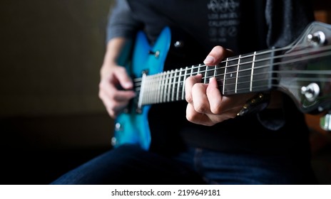 Guitarist Man Playing Guitar, A Man Sitting And Practicing Electric Guitar With Copy Space For Text