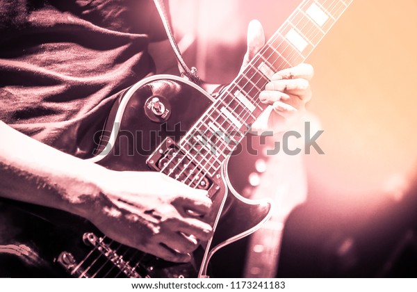 Guitarist on stage for background, soft and blur concept. Close up hand ...