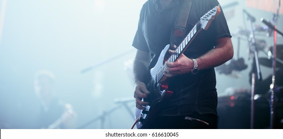 Guitarist performing on stage. Concert