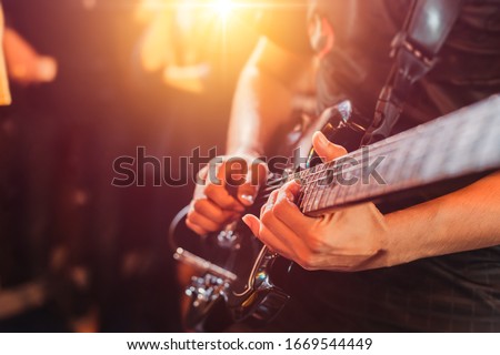 Guitarist play music song on stage.
