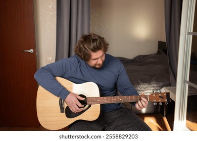 Guitarist playing Acoustic Guitar, hand strumming strings, practicing chords - Powered by Shutterstock