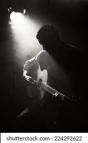 Guitarist Playing Acoustic Guitar. Unplugged Performance In The Dark.