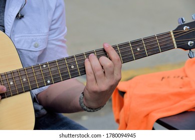 Guitarist playing at an outdoor setting.