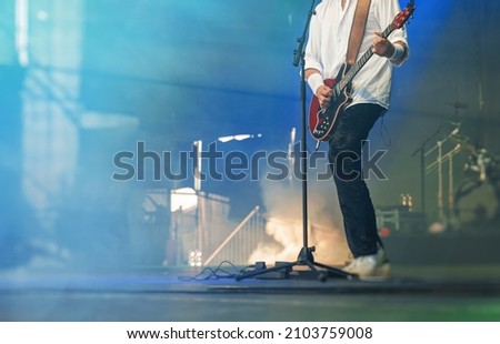 Guitarist playing solo on the live musical concert.