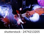 Guitarist plays the electric guitar during the concert