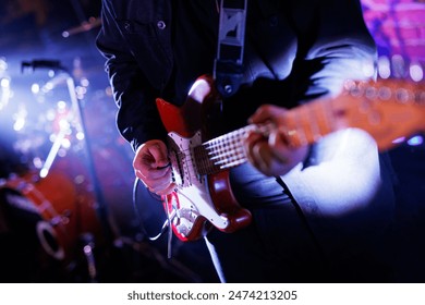 Guitarist plays the electric guitar during the concert - Powered by Shutterstock