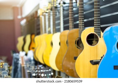 Guitars Hanging In Musical Showroom At Musical Instrument Store.