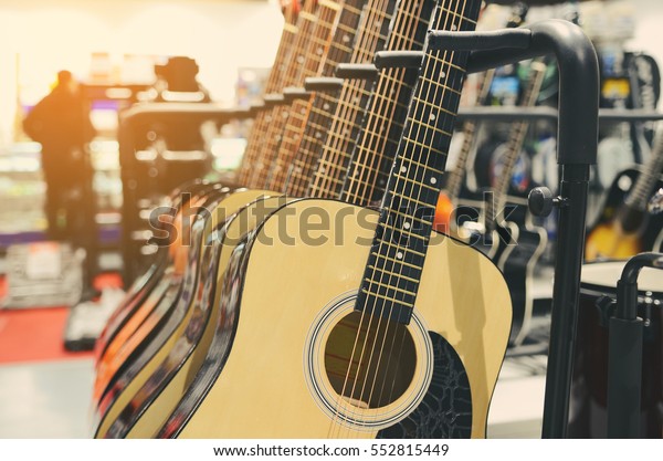 guitars  for sale\
hanging in a music\
store.