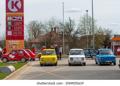 Gulbene, Latvia - May 02, 2021: more colorful vintage cars Fiat 126 gathered at the gas station, a fun trip or adventure concept