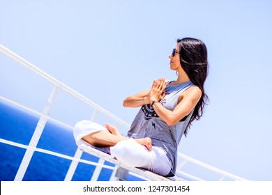 Gulf Of Aden, Indian Ocean - 2018.
Portrait Of Young Woman Doing Yoga While Sailing The Gulf Of Aden.