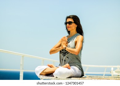 Gulf Of Aden, Indian Ocean - 2018.
Portrait Of Young Woman Doing Yoga While Sailing The Gulf Of Aden.