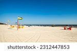 Gulf coast beach in Biloxi, Mississippi with water tricycles and lounge chairs.