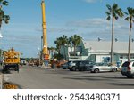 Gulfport, FL, USA. All-Terrain Yellow Crane  used to help pick up and move large derelict boat near Gulfport Casino Building after Hurricane Milton. 
