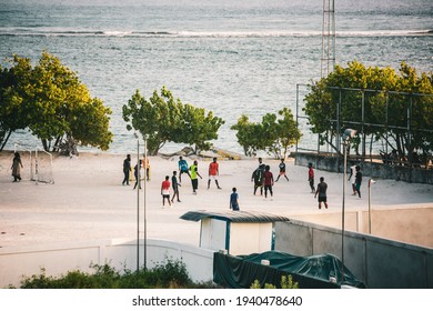 GULHI, MALDIVES - March 2021: Local Maldivian Kids Playing Football In The Evening, Gulhi, Maldives