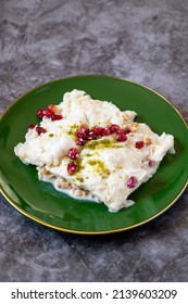Gullac dessert on dark background. Traditional Ramadan dessert. Güllaç dessert decorated with pistachio and pomegranate. Turkish cuisine delicacies. Close up - Shutterstock ID 2139603209