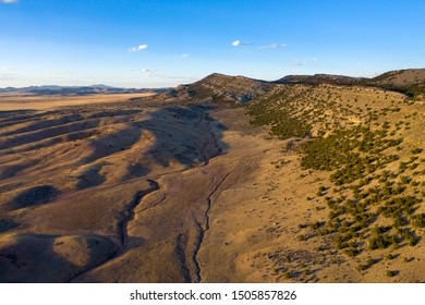 Gully Erosion Alongside An Outcropping In The Utah Desert.