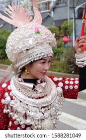 Gulong, China - October 25, 2019: At Lusheng Festival, portrait of a woman, wearing typical clothes and headgear of Miao minority 