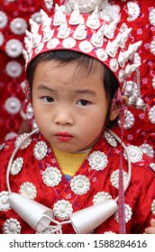 Gulong, China - October 25, 2019: At Lusheng Festival, portrait of a female child, wearing typical clothes and headgear of Miao minority 