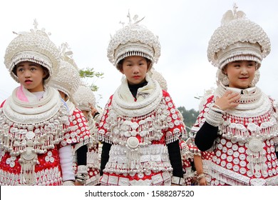 Gulong, China - October 25, 2019: At Lusheng Festival, portrait of women, wearing typical clothes and headgear of Miao minority 