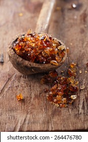 Gum arabic, also known as acacia gum - in old wooden spoon