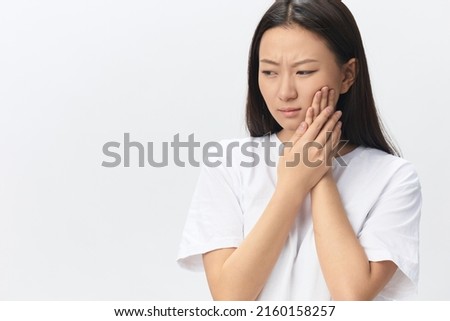 Gumboil Dental abscess Toothache Broken Tooth. Unhappy crying suffering tanned beautiful young Asian woman touch cheek at home interior living room. Injuries Poor health Illness concept. Cool offer