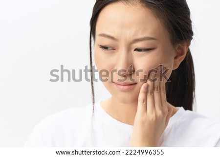 Gumboil Dental abscess Wisdom teeth Periodontitis. Unhappy suffering tanned pretty young Asian woman touch cheek posing isolated on white background. Injuries Poor health Illness concept. Cool offer