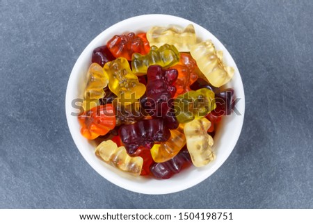Gummy bears sweets gummybears from above bowl on a slate