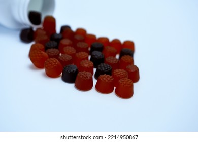 Gummy Vitamins In Berry Flavors On A White Background With A Bottle. Vitamin - C For Children.
