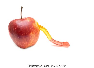 Gummy Worm Coming Out Of A Fresh Red Apple Isolated On White