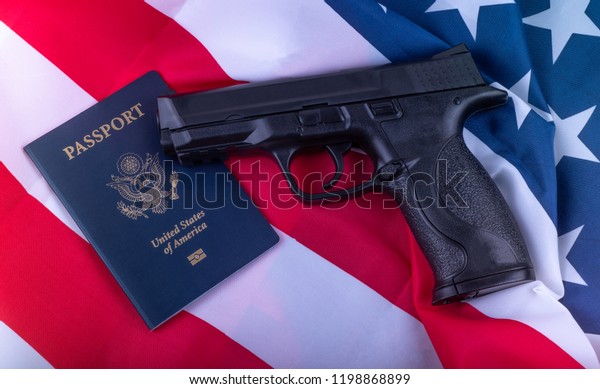 Gun and American Passport on Flag of\
USA  Background. Gun violence in the USA concept.\
