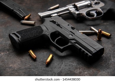 Gun with ammunition on dark background.