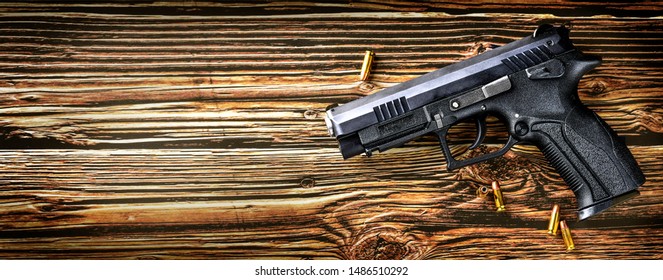 Gun With Ammunition On Dark Stone Background. Guns Ammo Or Rounds Military Picture Top View.