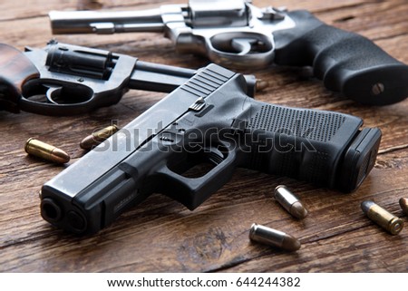 gun-ammunition-on-wooden-background-450w-644244382.jpg