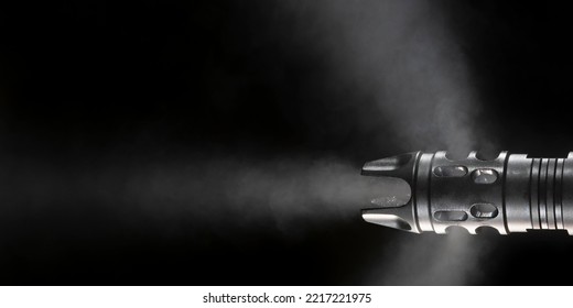 Gun Barrel After Firing With Smoke On A Black Background With Room For Copy
