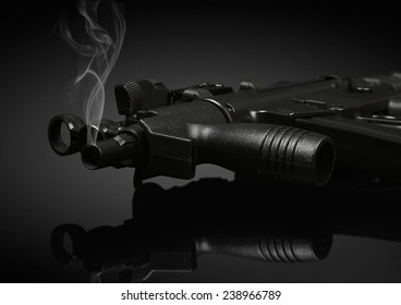 Gun Barrel With Smoke On Black Background. Soft Focus