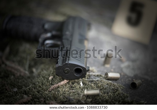 gun with a cartridge on the surface of a rusty
metal sheet