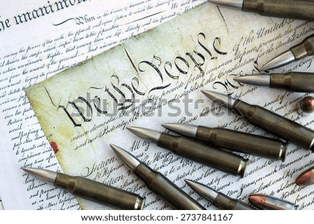 Gun control and second amendment in America concept. Bullets on american constitution with close up on We The People part of the United States constitution