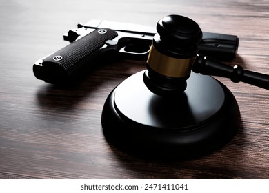 Gun and gavel on the table.