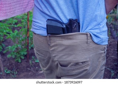 The gun is hidden behind the man's back