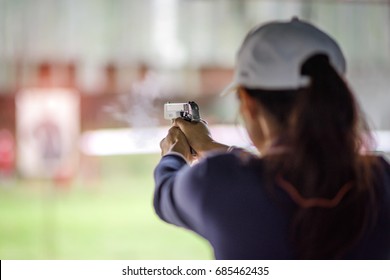 gun holding in hand of woman in practice shooting in martial arts for self defense in an emergency case