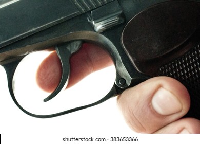 gun in a human hand on a background of old boards
