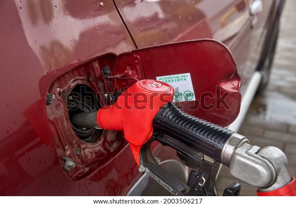 the gun is\
inserted into the gas tank of the\
car
