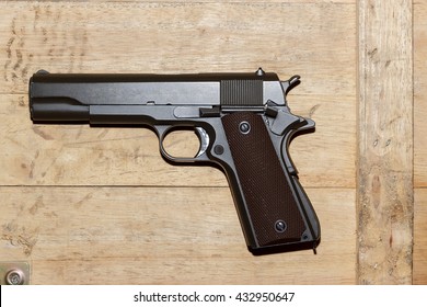 Gun on old wood background
