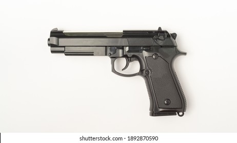 A gun on a white background. Flat lay view.