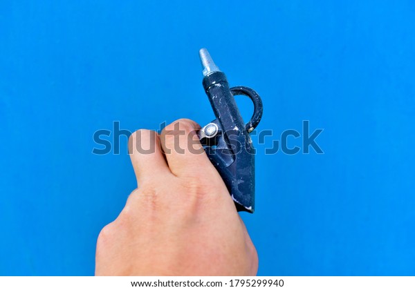 Gun
for painting surfaces spray gun on a blue
background