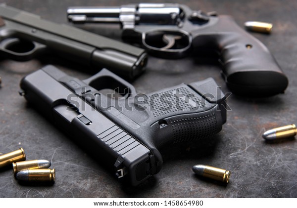 Gun, Pistol\
 with ammunition on wooden\
background.