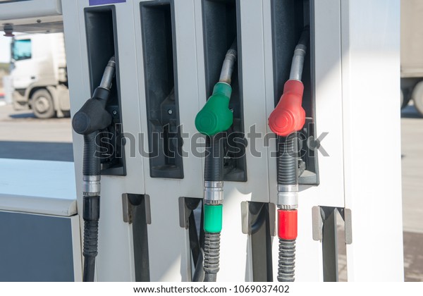 Gun for refueling at a gas station.\
Gasoline. Oil. Fuel Pump. Gas Station. Colorful Petrol pump filling\
nozzles isolated on white background. \
