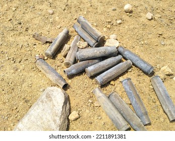 Gun Shells Found On Old Shooting Range On The Sand Close Up