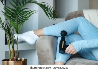 Gun Shock Vibration Percussion Massage Therapy. Cute Woman Practicing Self-massaging Your Legs Close Up. Applying Therapeutic Percussive Massage Gun In Living Room At Home Indoors. Copy Text Space