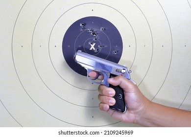 Gun and shooting target With Bullet Holes. Classic Paper Shooting Target. Holes In Target. For Sport, Hunters, Military, Police. Sport shooting circle target accuracy bullet hole.